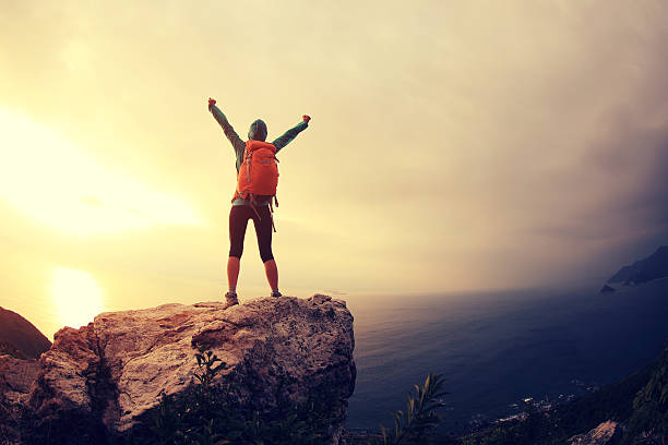istock successful hiker hiking on seaside mountain peak 638408242