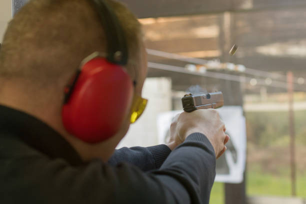 istock Shooting with a pistol. Man Firing pistol in shooting range. 638409068