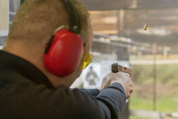 istock Shooting with a pistol. Man Firing pistol in shooting range. 638409142
