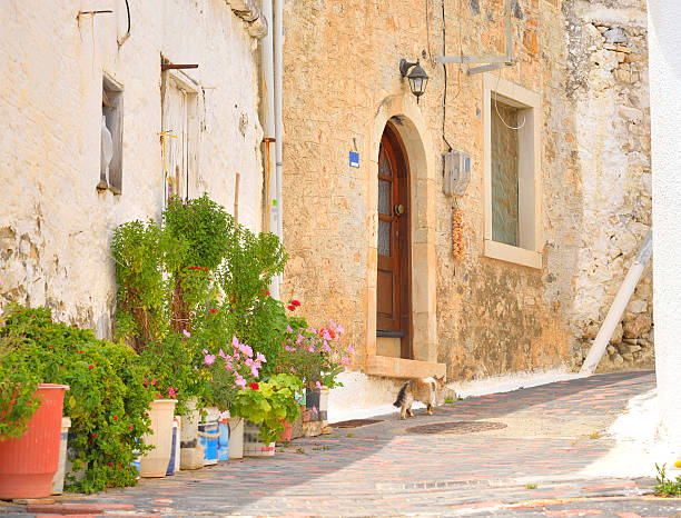 The narrow street with old houses in the historic part of Hersonissos, Crete, Greece.