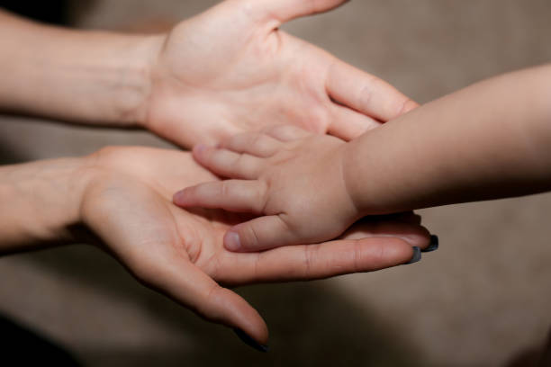 istock Mother holding her child's hand 638409996