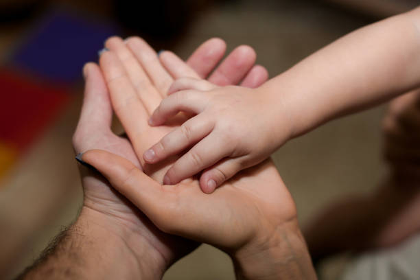 istock Tiny hand of son and big   dad  mother 638410190