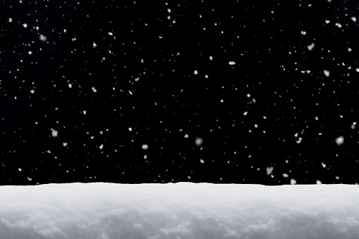 Winter background. falling snow isolated on black background with copy space