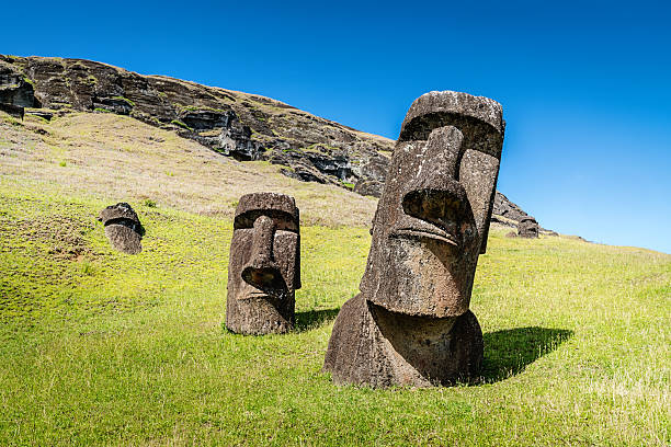 Easter Island Statues Rano Raraku Moais Rapa Nui Easter Island Moai Statues at Rano Raraku under sunny summer sky. Rano Raraku, Rapa Nui National Park, Hanga Roa, Easter Island, Chile. volcanic landscape photos stock pictures, royalty-free photos & images