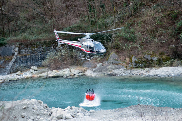istock Fire fighting helicopter collecting water 638412522