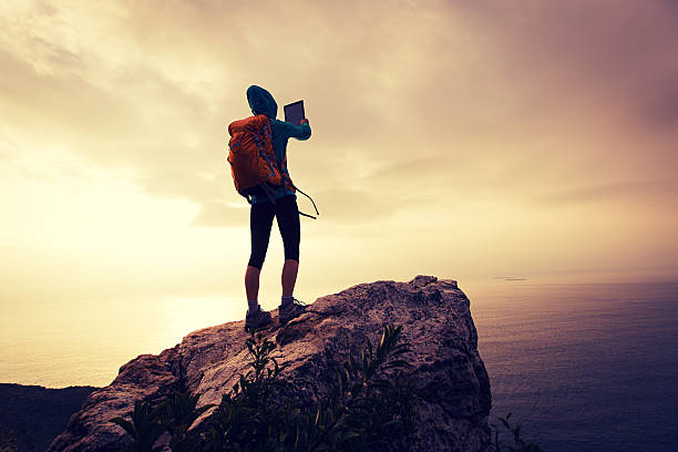istock hiker use digital tablet taking photo on seaside mountain peak 638414078