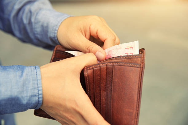 istock Hands taking  money  out from wallet on the street 638414330