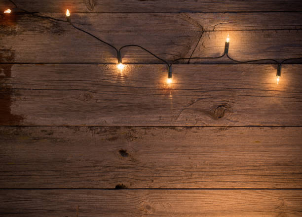 istock Christmas lights on wooden background 638414934
