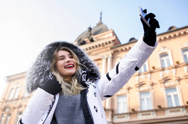 istock Young woman taking selfie on winter 638417810