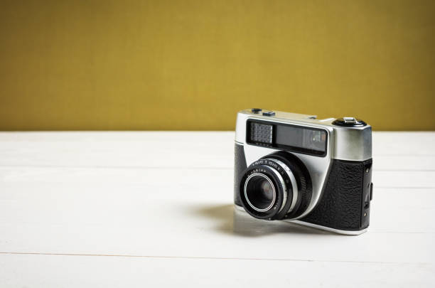 istock Retro camera on a white wooden desk 638417976