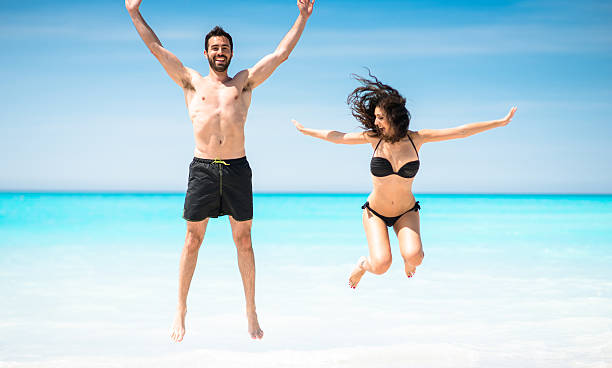 istock Happiness couple at the seaside jumping on the beach 638417980