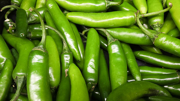 istock Fresh, organic bright green chilli peppers at supermarket. 638419782