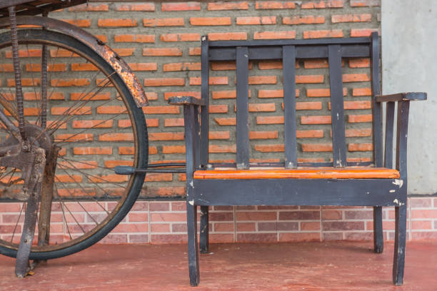 istock Wooden chairs on orange brick walls and old bicycles 638419894