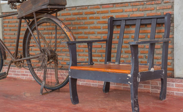 istock Wooden chairs on orange brick walls and old bicycles 638423340