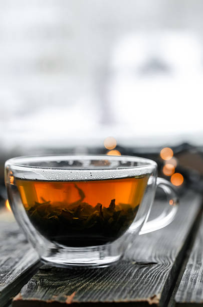 istock Transparent Cup of tea on wooden background 638424112