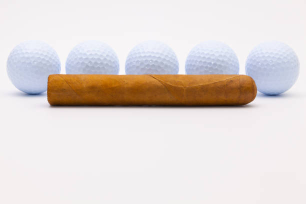istock Luxury Cuban cigar and white golf balls 638424144