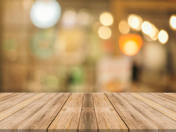 istock Wooden board empty table in front of blur in  mall 638427084