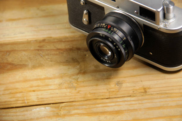 istock Retro photo camera on wooden the background 638428496