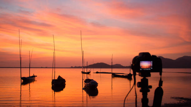 istock Camera standing on tripod at sunset at the sea. 638429012