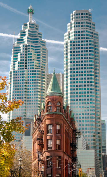 Toronto City Skyline Architecture Flatiron Building Toronto, Ontario Canada and its famous historic flatiron building. Fall colors and blue sky. flatiron building toronto stock pictures, royalty-free photos & images