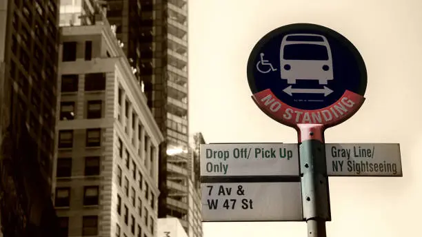 Nice street-signs on a bus stop somewhere in NYC