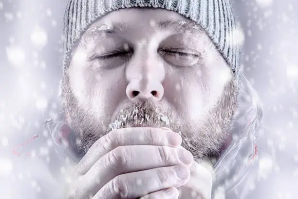 Photo of Man freezing in snow storm white out close up