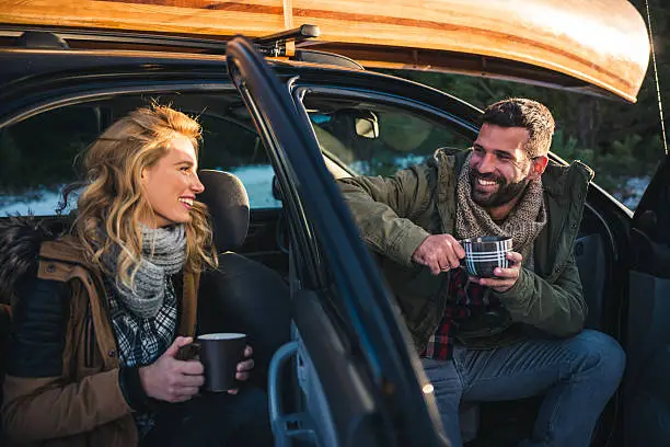 Couple enjoying roadtrip and making a break for coffee.