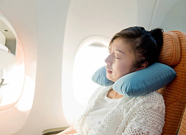 istock Young asian woman sleeping on airplane 638438590