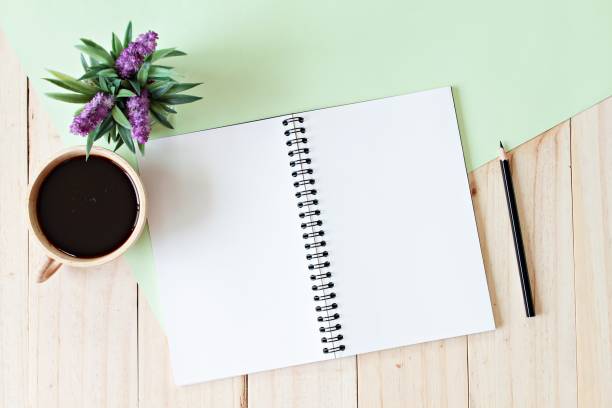 istock Open notebook with blank pages, coffee cup on wooden background 638439084