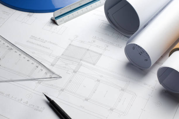 istock Architectural blueprints and blueprint rolls and a drawing instr 638439438