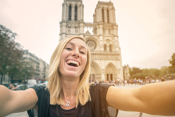 istock Young woman taking selfie with Notre Dame de Paris cathedral 638439850