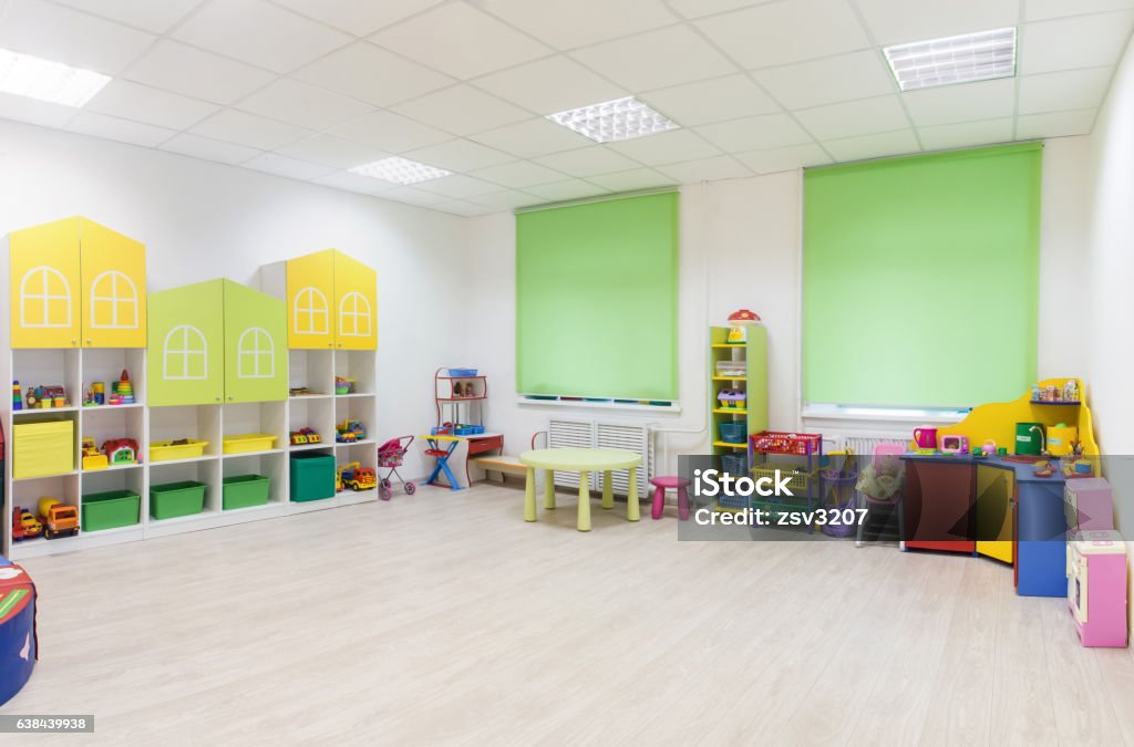 Bright Interior of a modern kindergarten in yellow and green Light interior of a modern kindergarten in yellow and green colors. Panorama. Playroom Stock Photo