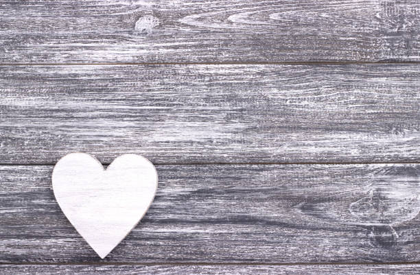 istock Decorative white heart on gray wooden background with copy space. 638439970