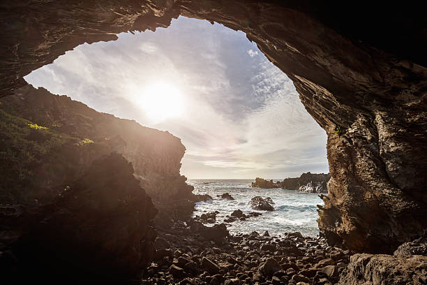 Ana Kai Tangata Cave Sunset Easter Island Rapa Nui Chile Ana Kai Tangata Cave Entrance Easter .Ana Kai Tangata is one of the most interesting and accesible caves on the island. Its name has led to various speculations due to the different translations. On one hand, Ana, means “cave”; Tangata, means “man”; and Kai, means “to eat” in modern Rapa Nui. For which, the cave is referred to as “the cave of the cannibals” or of the “man-heaters”. However, there is no archaeological proof or any oral traditions that confirm that the Rapa Nui practiced cannibalism. ana kai tangata stock pictures, royalty-free photos & images