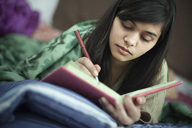 istock Girl student studying in bed at home. 638441566