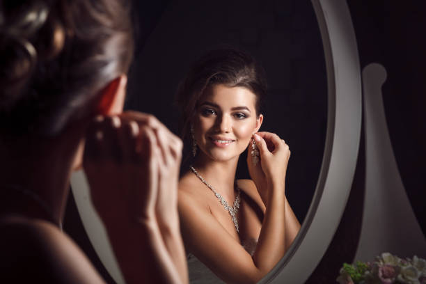 istock Beautiful young bride sitting near mirror 638441576