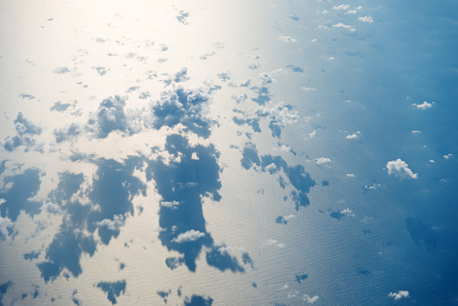 Aerial view of seascape with clouds over it