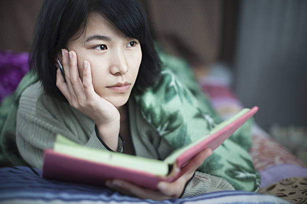 istock Girl student studying in bed at home. 638442176