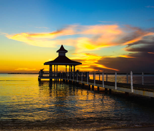 gazebo bridge in the sea at sunset evening sky