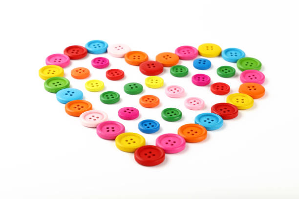 istock Heart shaped of colorful sewing buttons on white 638445682