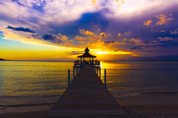 gazebo bridge in the sea at sunset evening sky