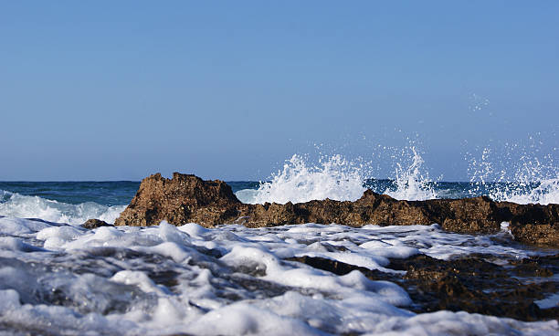 istock White foamy water and brown rocks 638447560