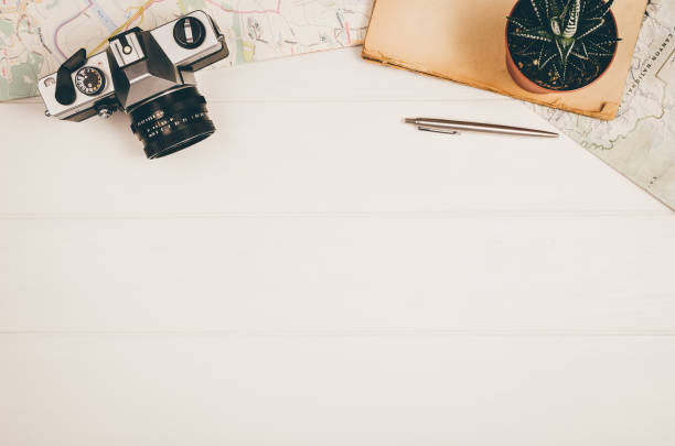 Accessories for travel top view on white wooden background with copy space. Adventure and wanderlust concept image with travel accessories. Preparing for an exotic trip, journey and sightseeing.