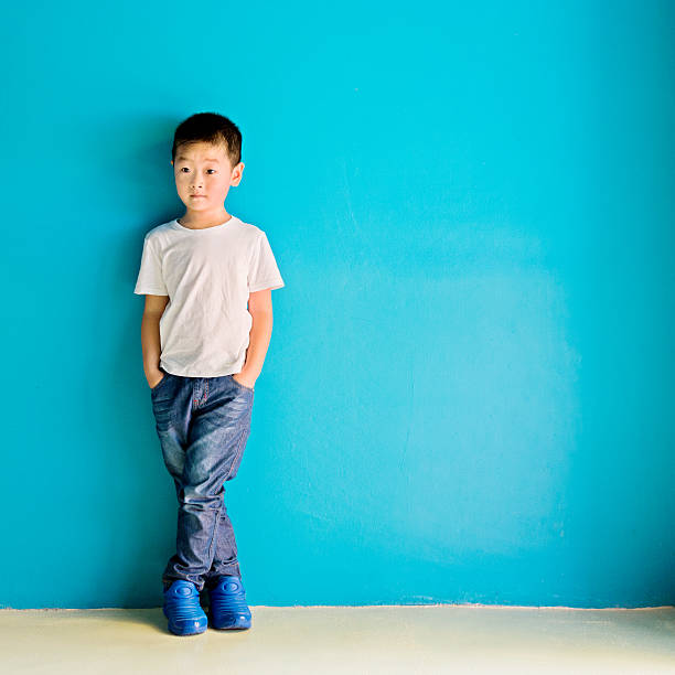 istock Chinese little boy against wall 638450670
