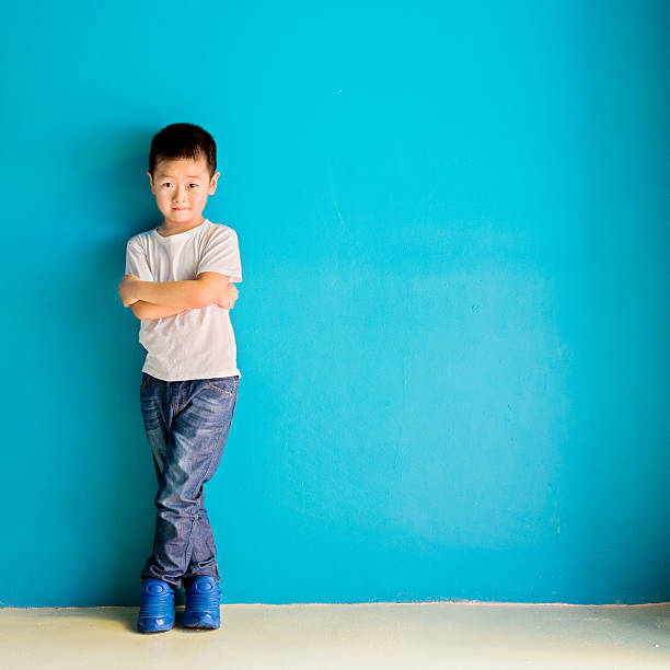 istock Chinese little boy against wall 638450898