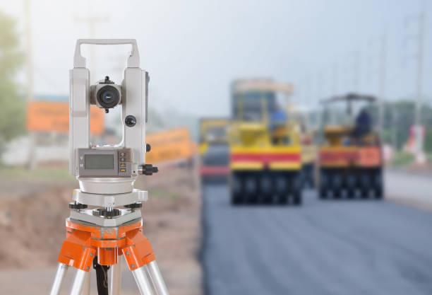 istock Survey equipment theodolite on a tripod. with road under constru 638450950