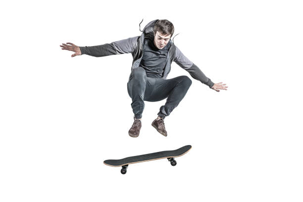 Jumping skateboarder isolated jumping skateboarder isolated against the white background Ollie stock pictures, royalty-free photos & images