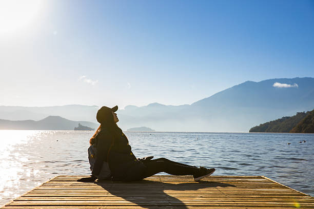istock Woman relaxing by a lake 638452516