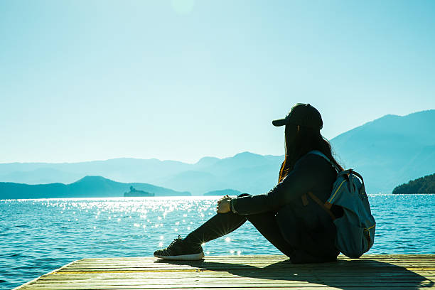 istock Woman relaxing by a lake 638452650