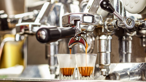Espresso Machine Pouring Coffee In Two Shot Glass Stock Photo